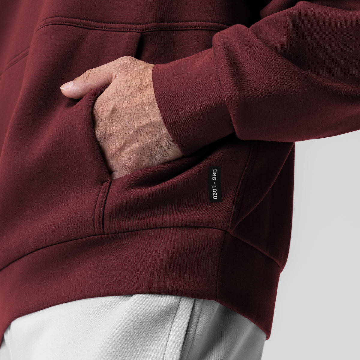 Dri-Core Oversized Crewneck in crimson, worn with hand in pocket detail