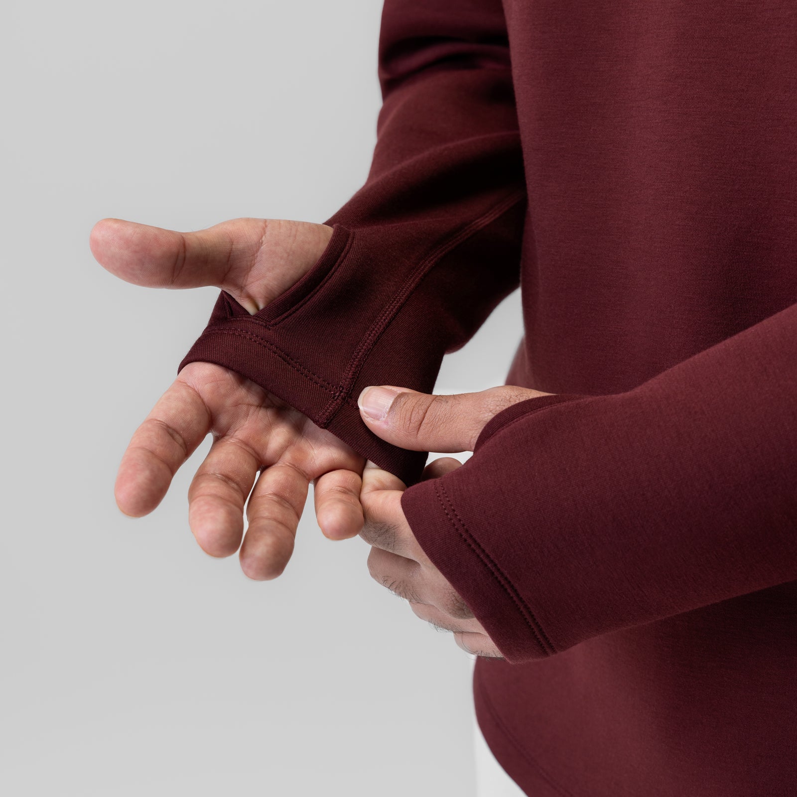 Dri-Core™ Zip Hoodie in Crimson, model wearing and showing thumb hole detail