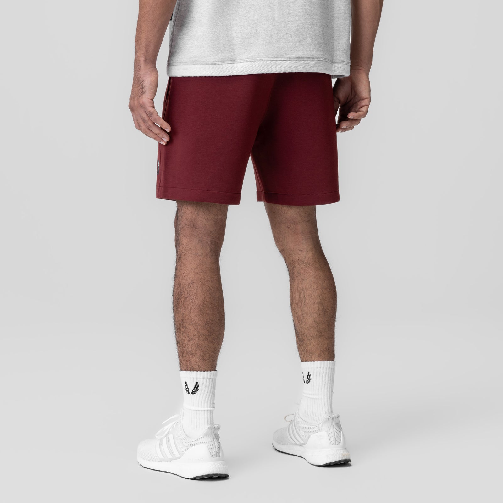 Dri-Core Training Short in crimson, modeled from behind with white socks and sneakers