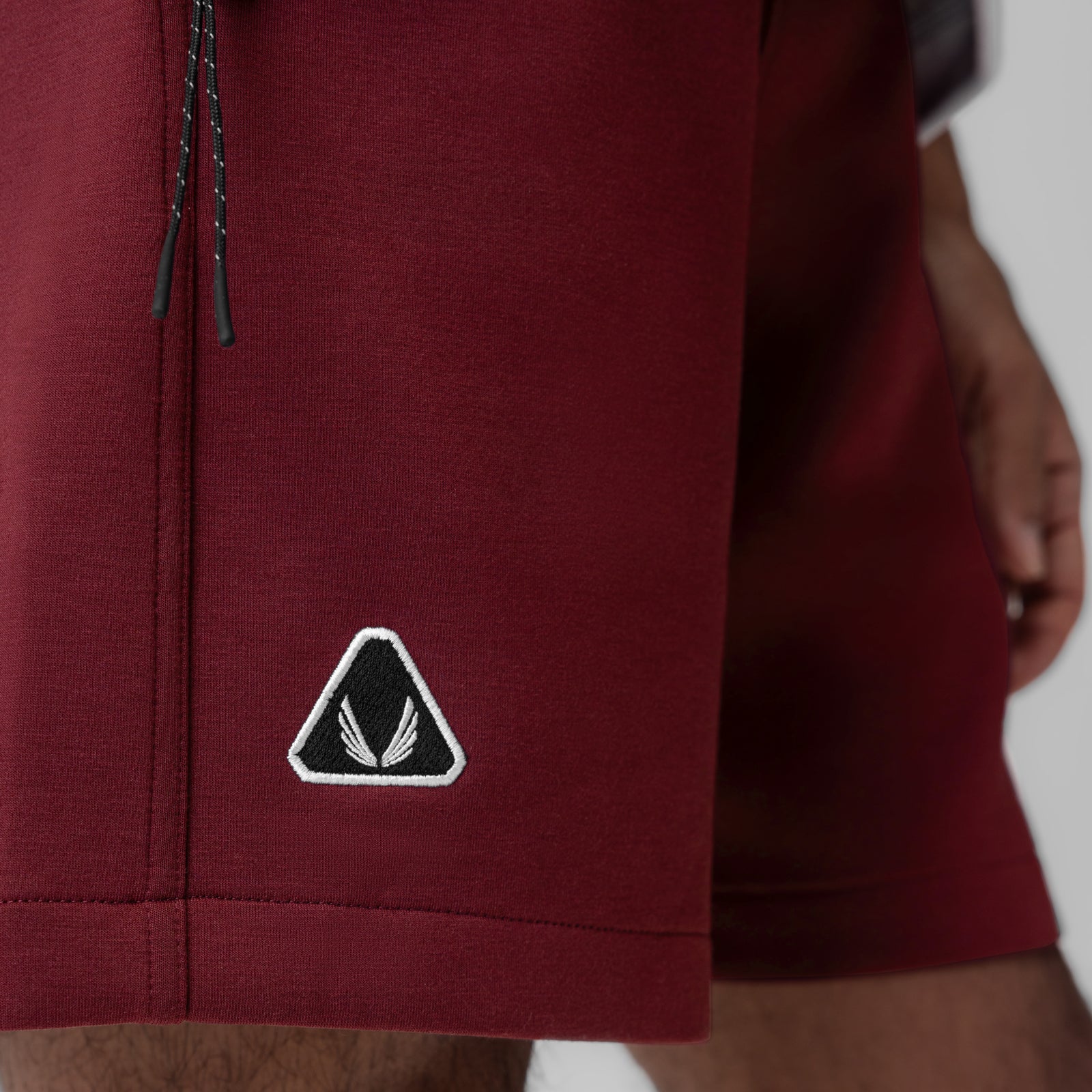 Dri-Core Training Short in crimson, worn on model showing side detail and logo