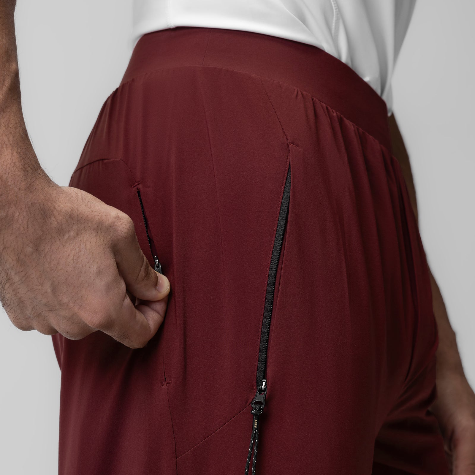 Aerotex Weather-Ready Bonded Pant in Crimson, side view with model holding pocket