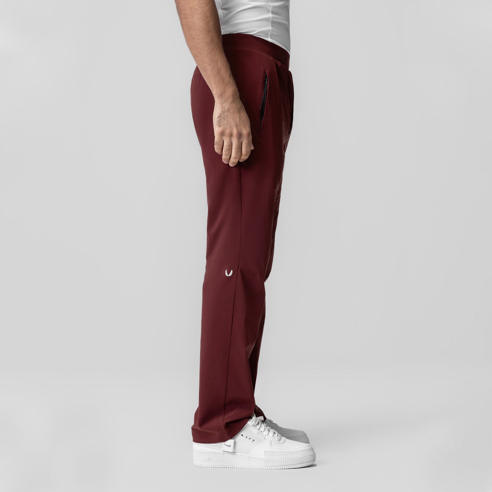 Aerotex Weather-Ready Bonded Pant in crimson, modeled from side profile with white sneakers