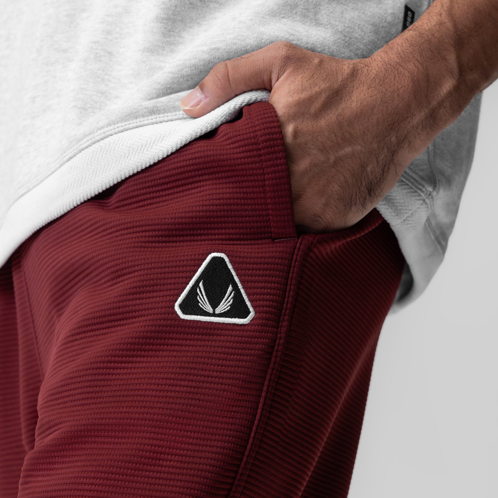 Deltapeak® Straight Leg Sweats in crimson, worn by model showing side pocket detail