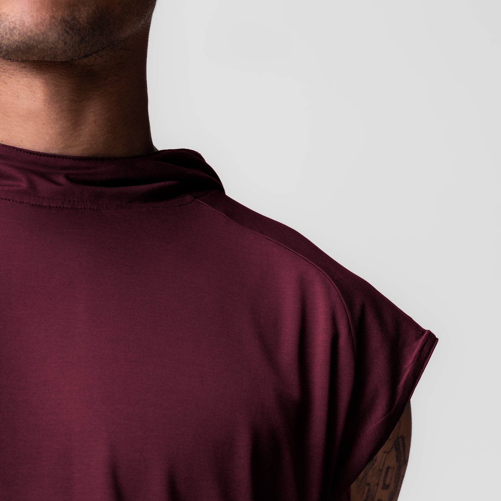 Reversible 2-in-1 Cutoff Hoodie in crimson, worn by model from shoulder back view