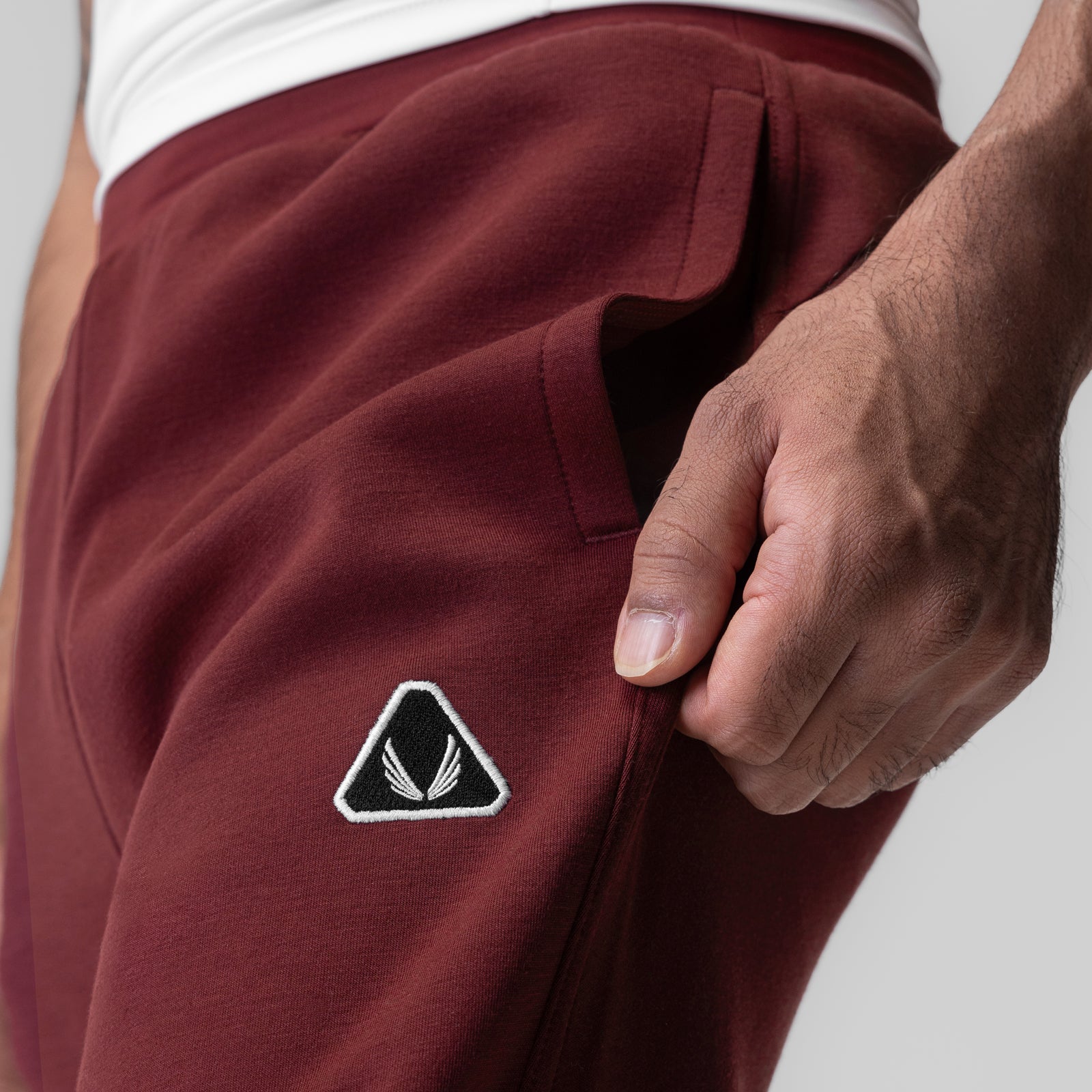 Dri-Core Training Jogger in Crimson worn by model, showing side pocket detail