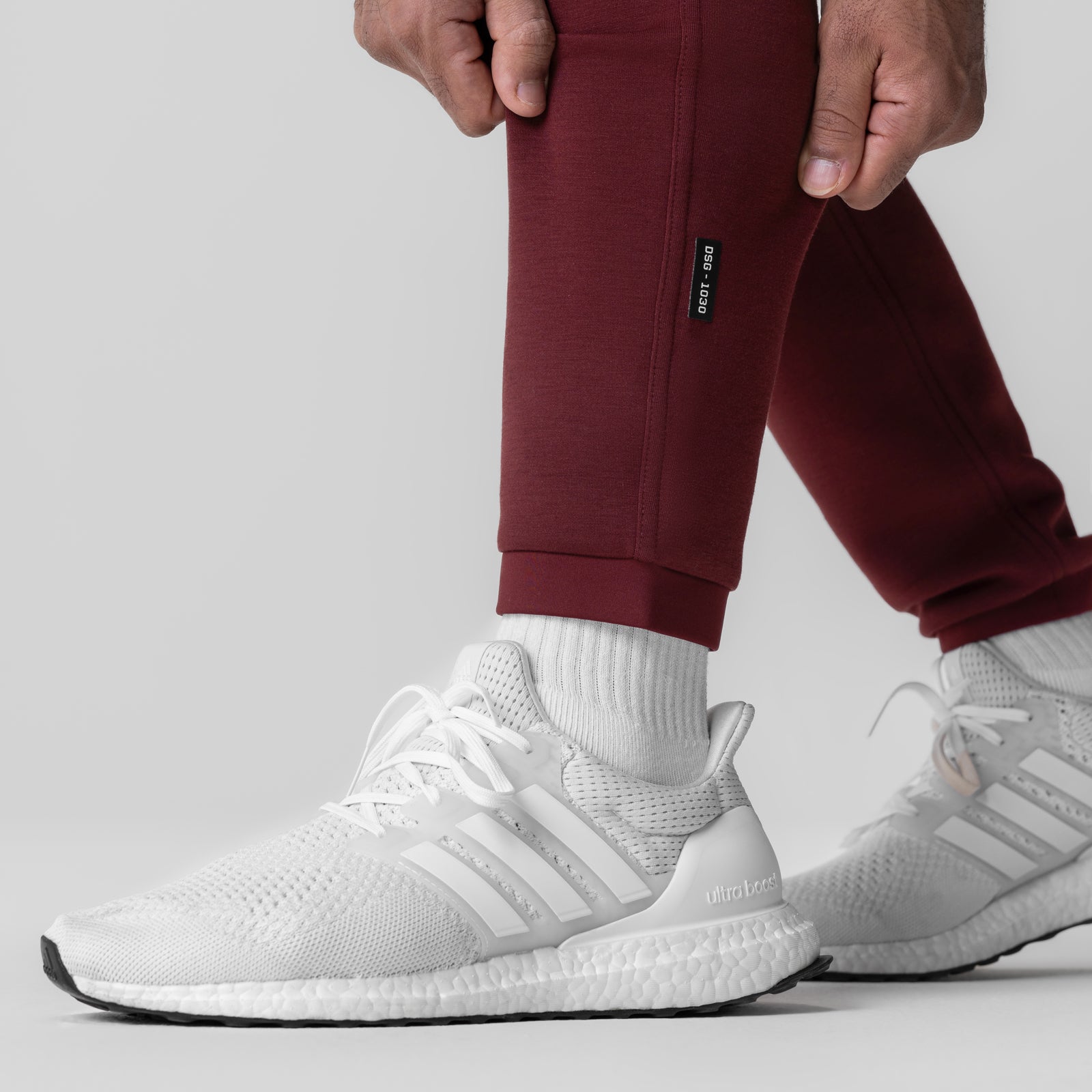 Crimson Dri-Core Training Jogger worn with white sneakers and white socks, side view
