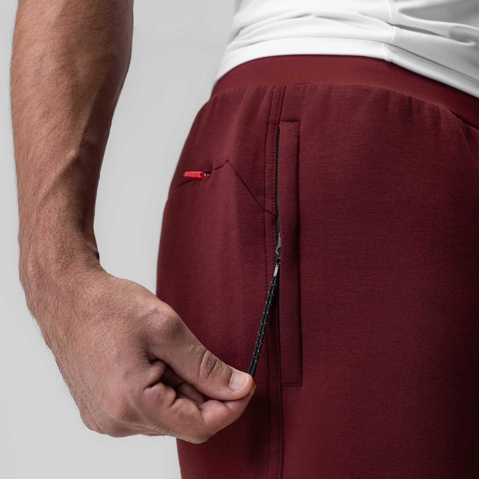 Dri-Core Training Jogger in crimson, worn by model showing side pocket detail