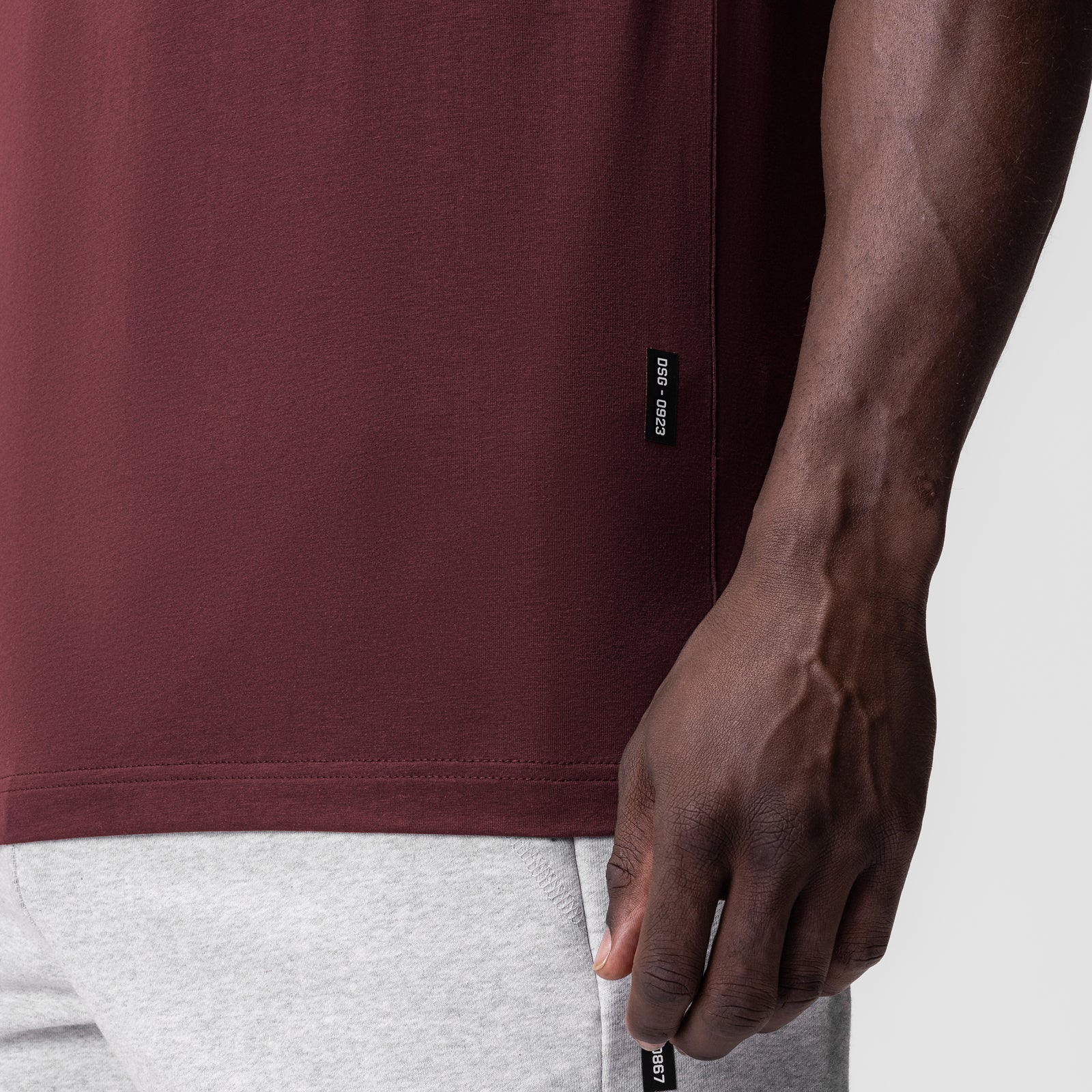Supima Essential Tee in Crimson worn by model, side detail view showing fit