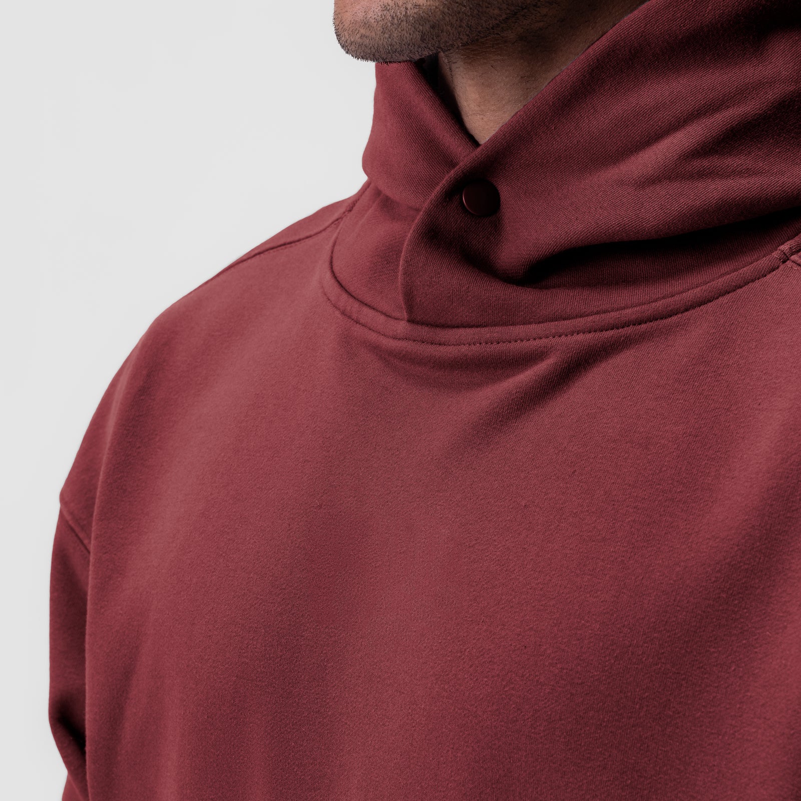 Tech-Terry Hoodie in Crimson worn by model, close-up of shoulder and hood detail