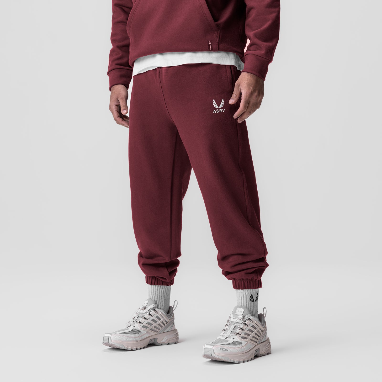 Tech-Terry Oversized Sweats in crimson worn by model with white sneakers, front view