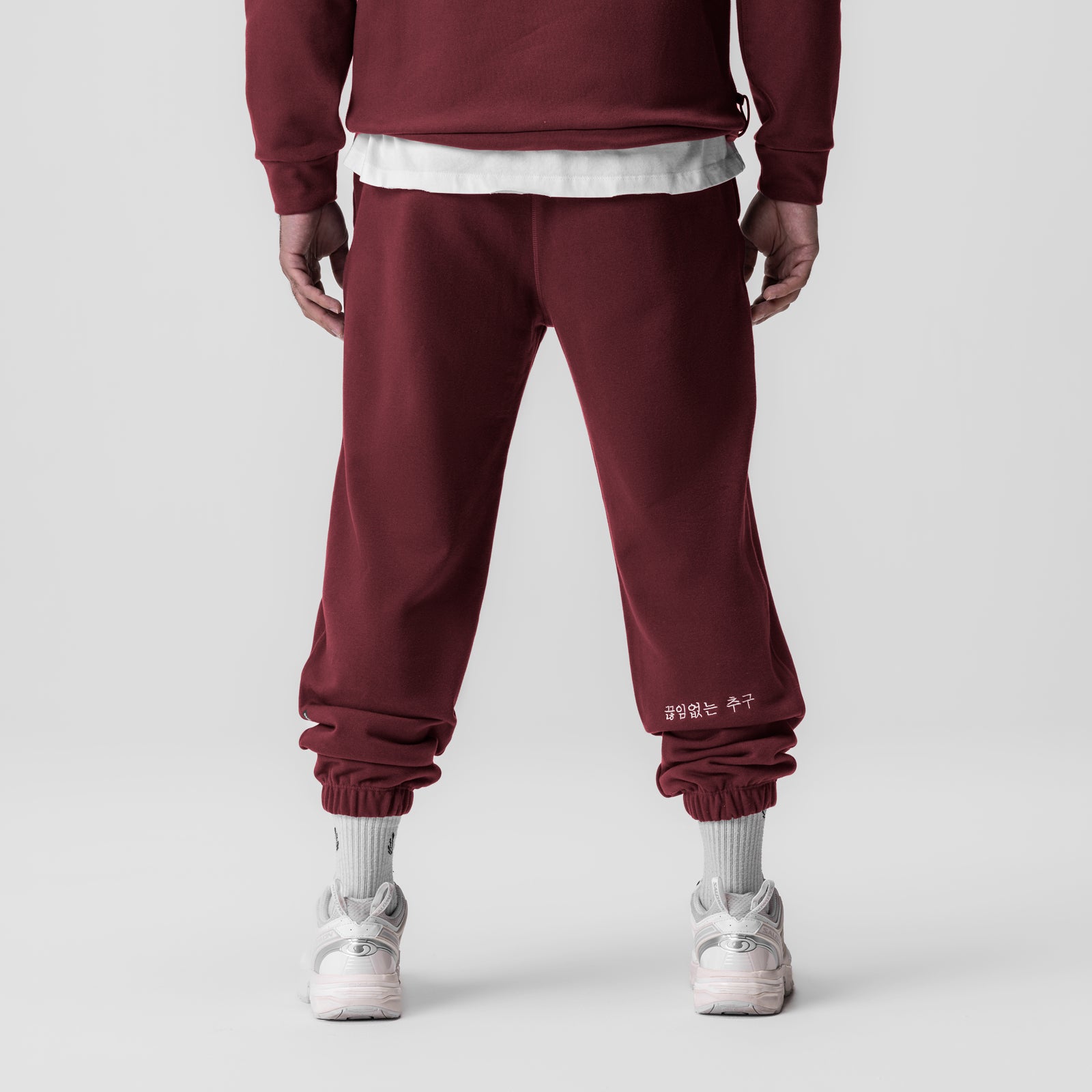 Tech-Terry Oversized Sweats in crimson worn by model, back view with white socks and sneakers