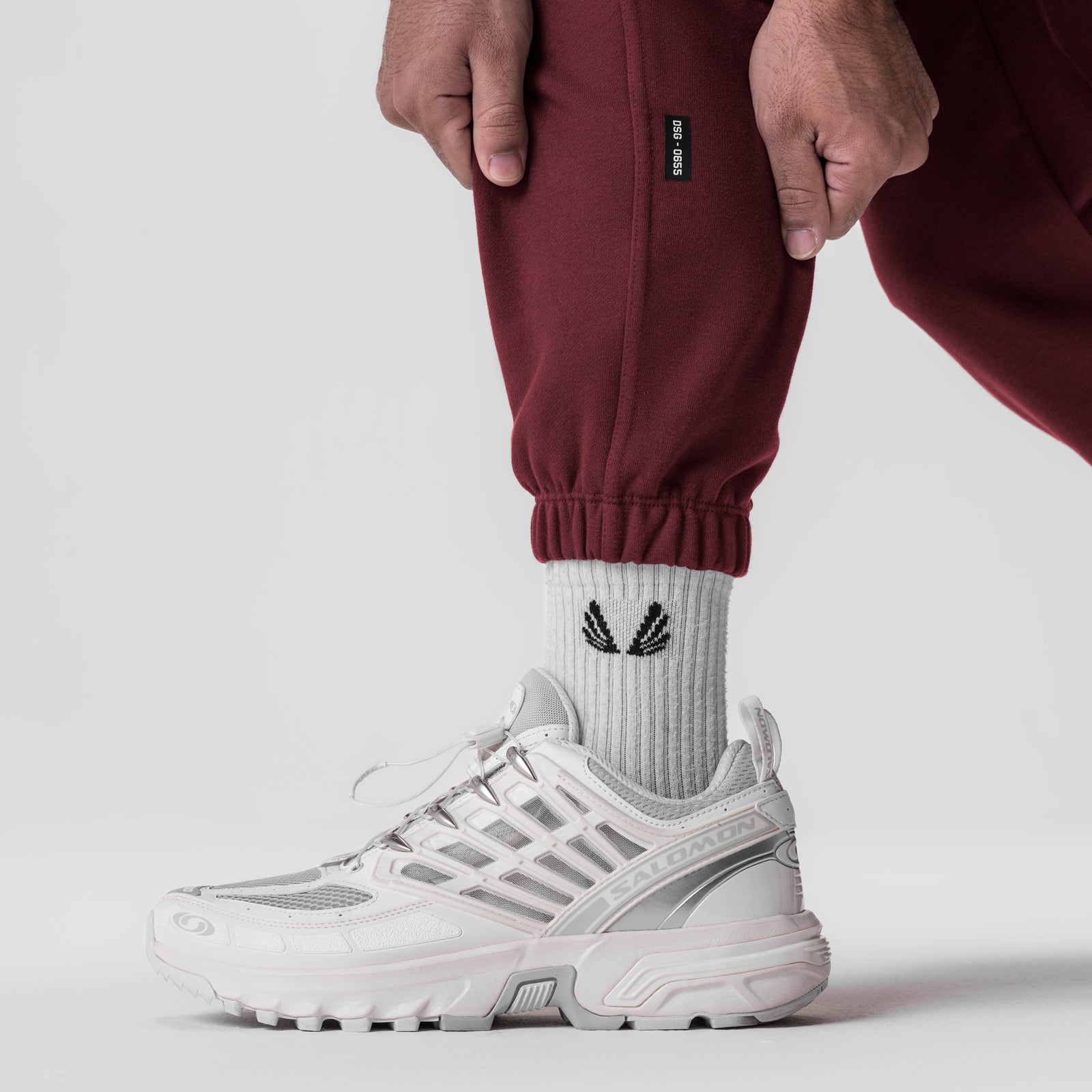 Tech-Terry Oversized Sweats in crimson worn with white sneakers and socks, detail view