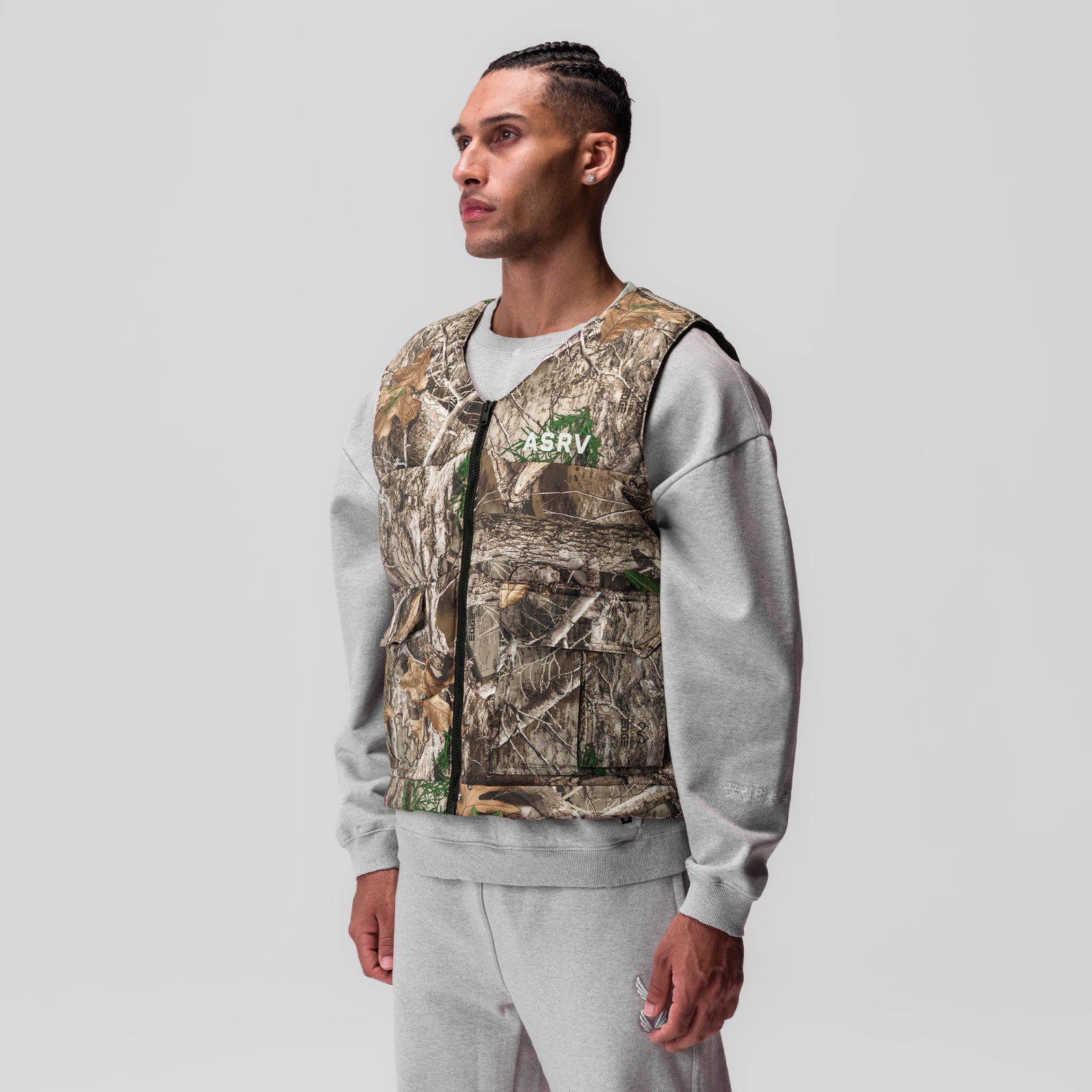 Ripstop Insulated Puffer Gilet in Realtree Camo with grey sleeves, worn by model, side view