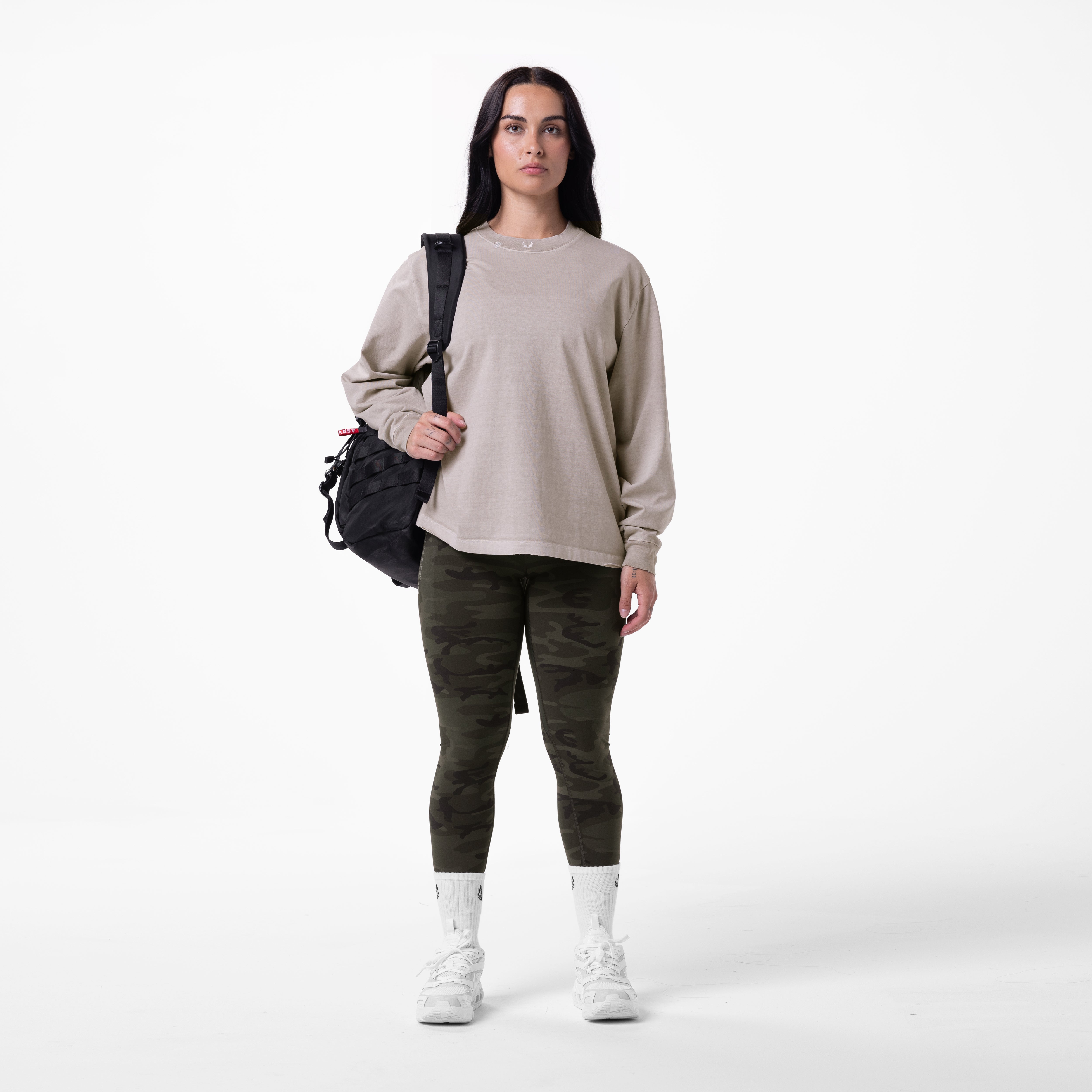 Tech Essential Relaxed Long Sleeve in Faded Chai worn with camo leggings and white socks