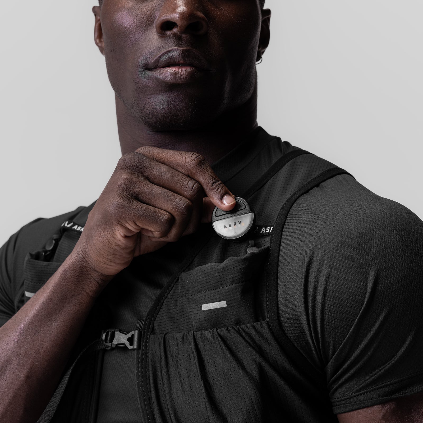 Black ASRV Eclipse vest worn by model, front view with hand positioning