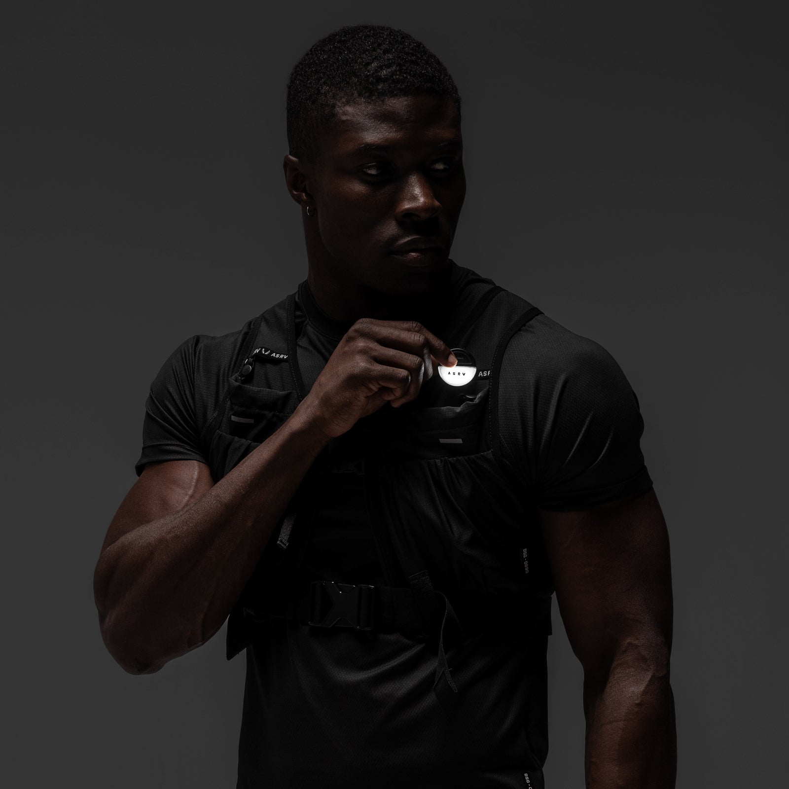 Black ASRV Eclipse vest worn by model, front view, chest badge detail visible