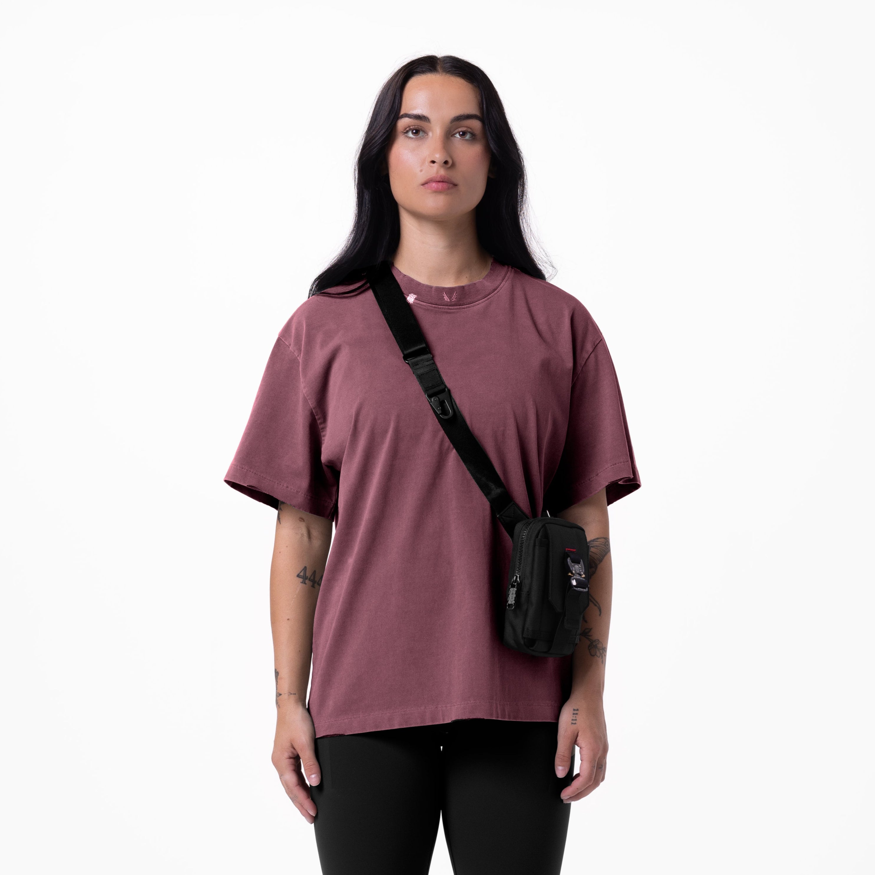 Tech Essential Relaxed Tee in faded crimson worn with black shoulder bag, front view