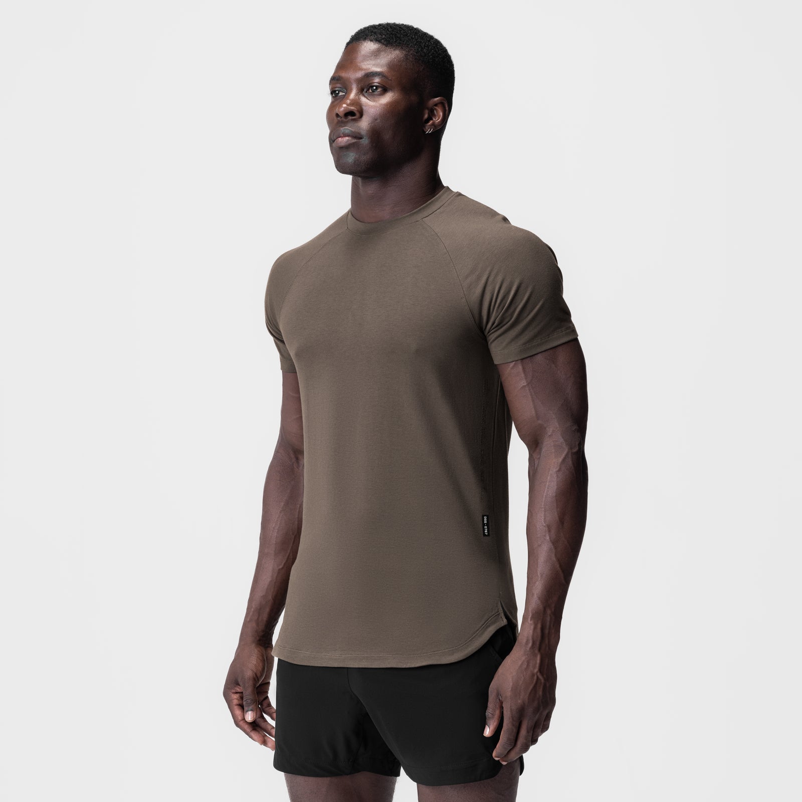 Deep taupe Supima® Established Tee worn by model with black shorts, side view