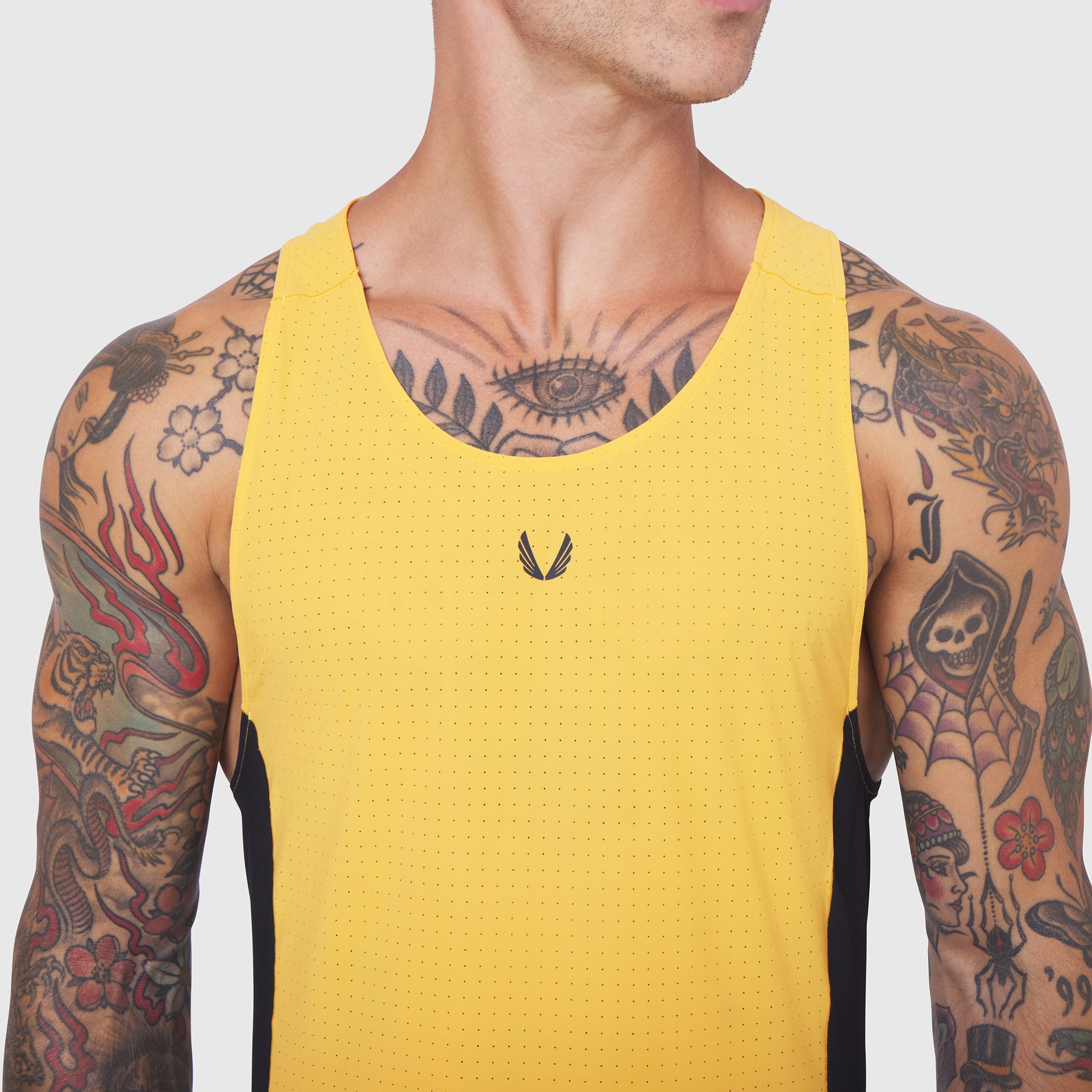 Laser-Vent™ Singlet Tank in Amber and Black worn by male model, front view