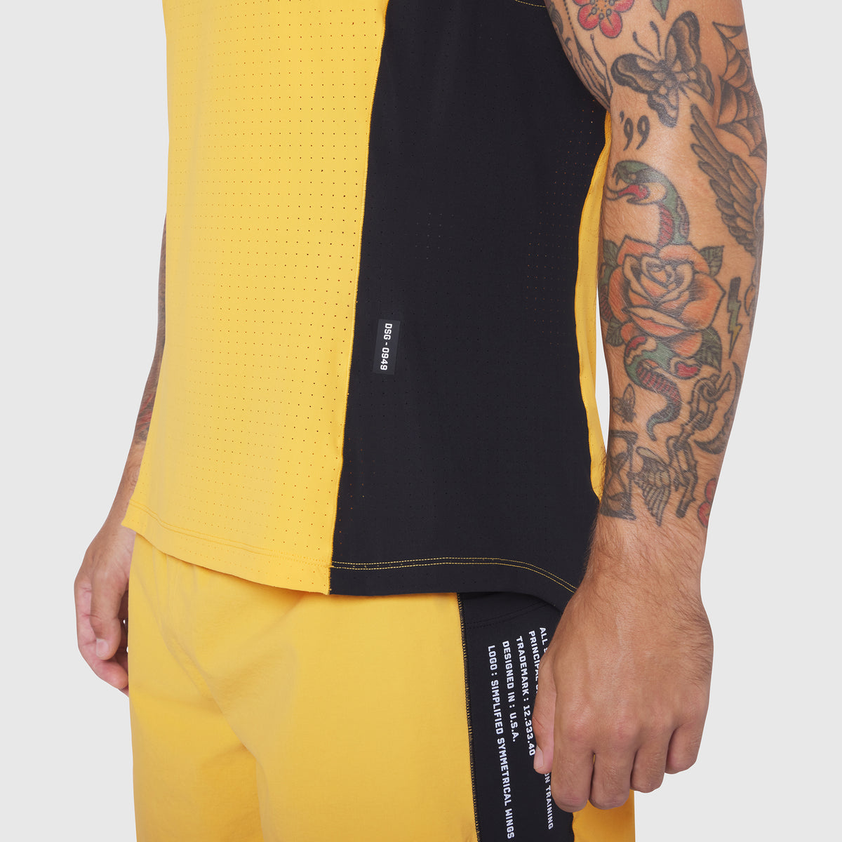 Laser-Vent Singlet Tank in amber and black, worn by model showing side view