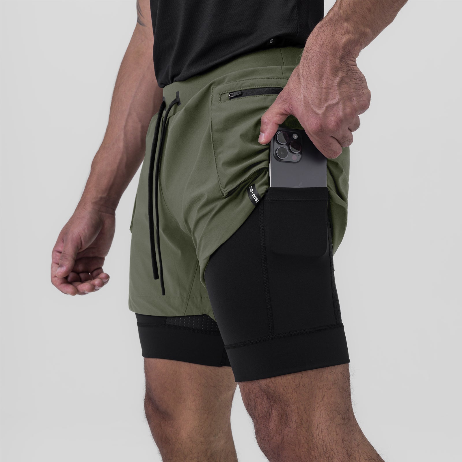 Tetra-Lite Liner Cargo Short in olive worn by model holding smartphone in pocket
