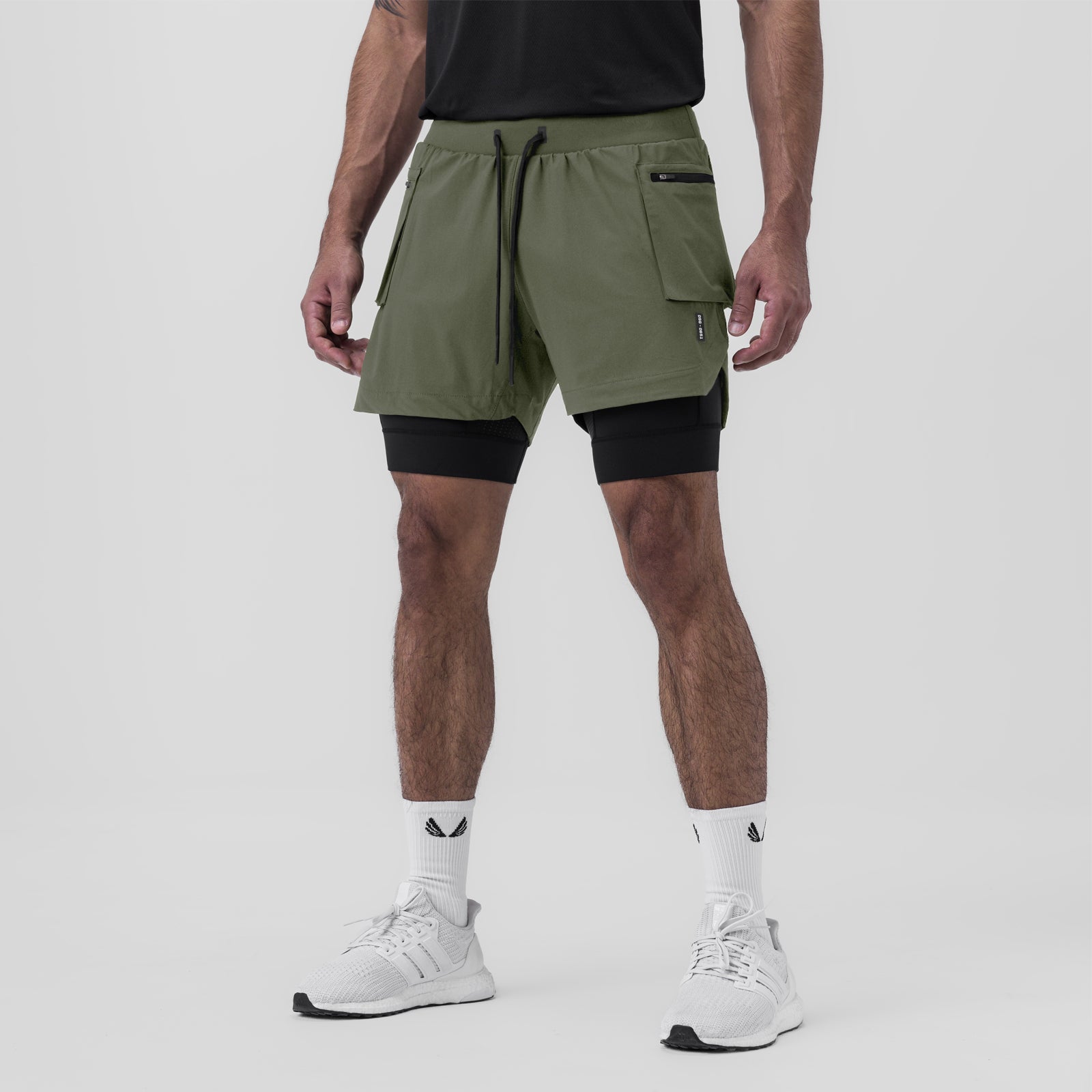 Tetra-Lite Liner Cargo Short in olive worn with black undershorts, front view on model