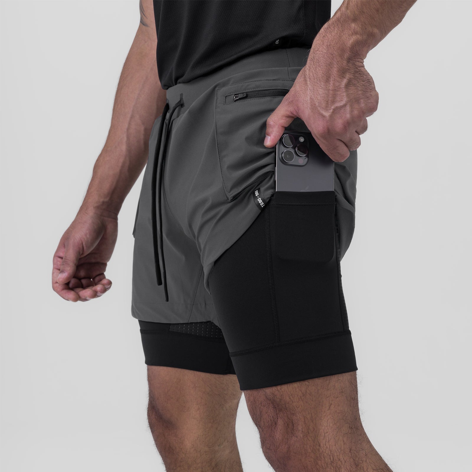 Tetra-Lite Liner Cargo Short in Space Grey, model holding phone in side pocket