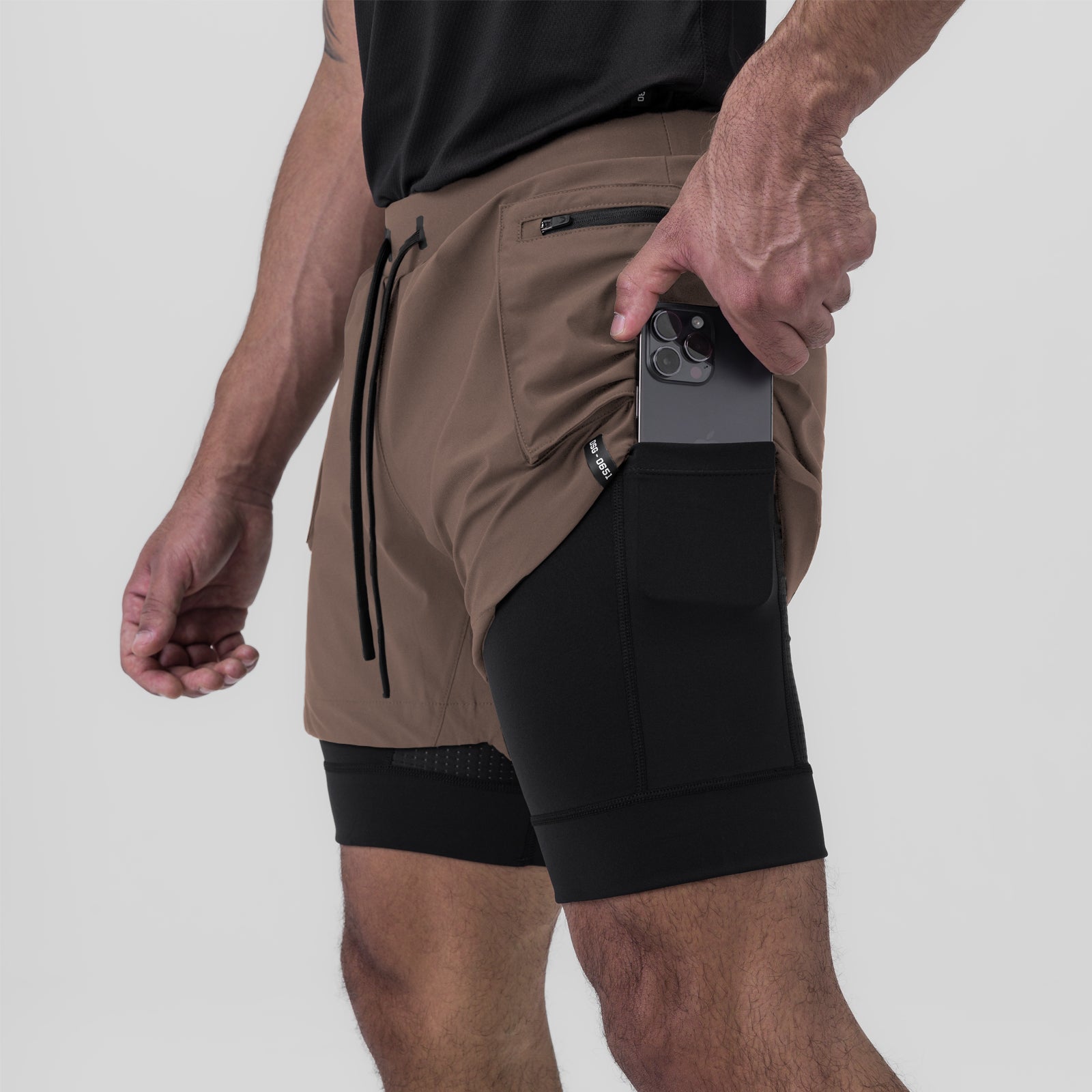 Tetra-Lite Liner Cargo Short in Deep Taupe, worn with model holding phone in pocket