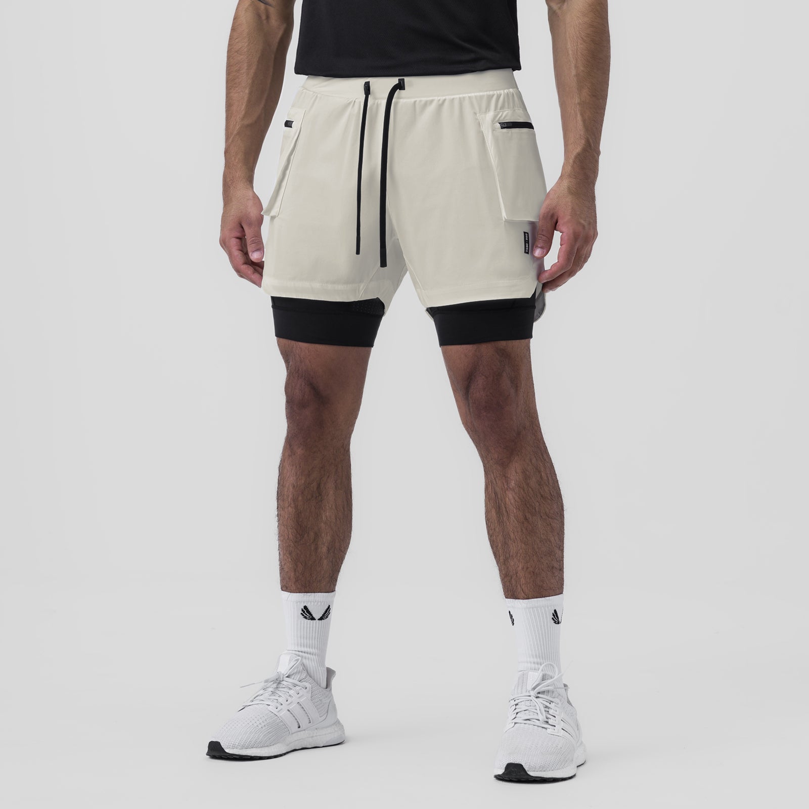 Tetra-Lite Liner Cargo Short in stone worn with black undershorts, front view on model