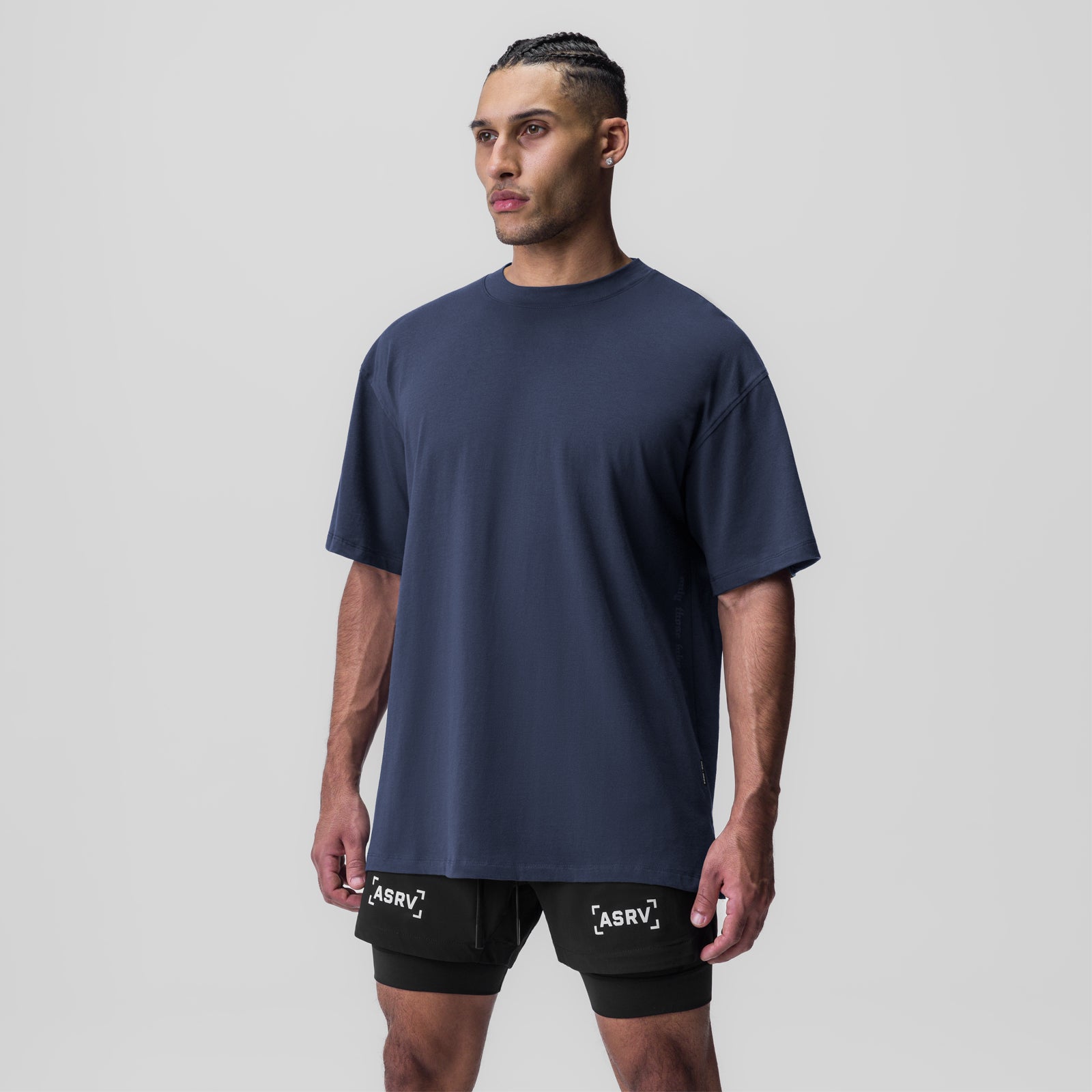 Navy oversized Supima tee worn with black shorts, front view on model