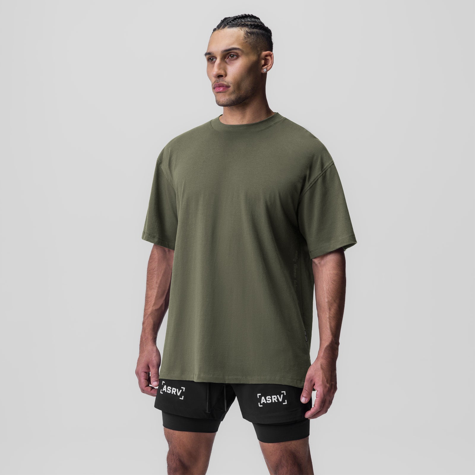 Olive green Supima oversized tee worn with black shorts, front view on model