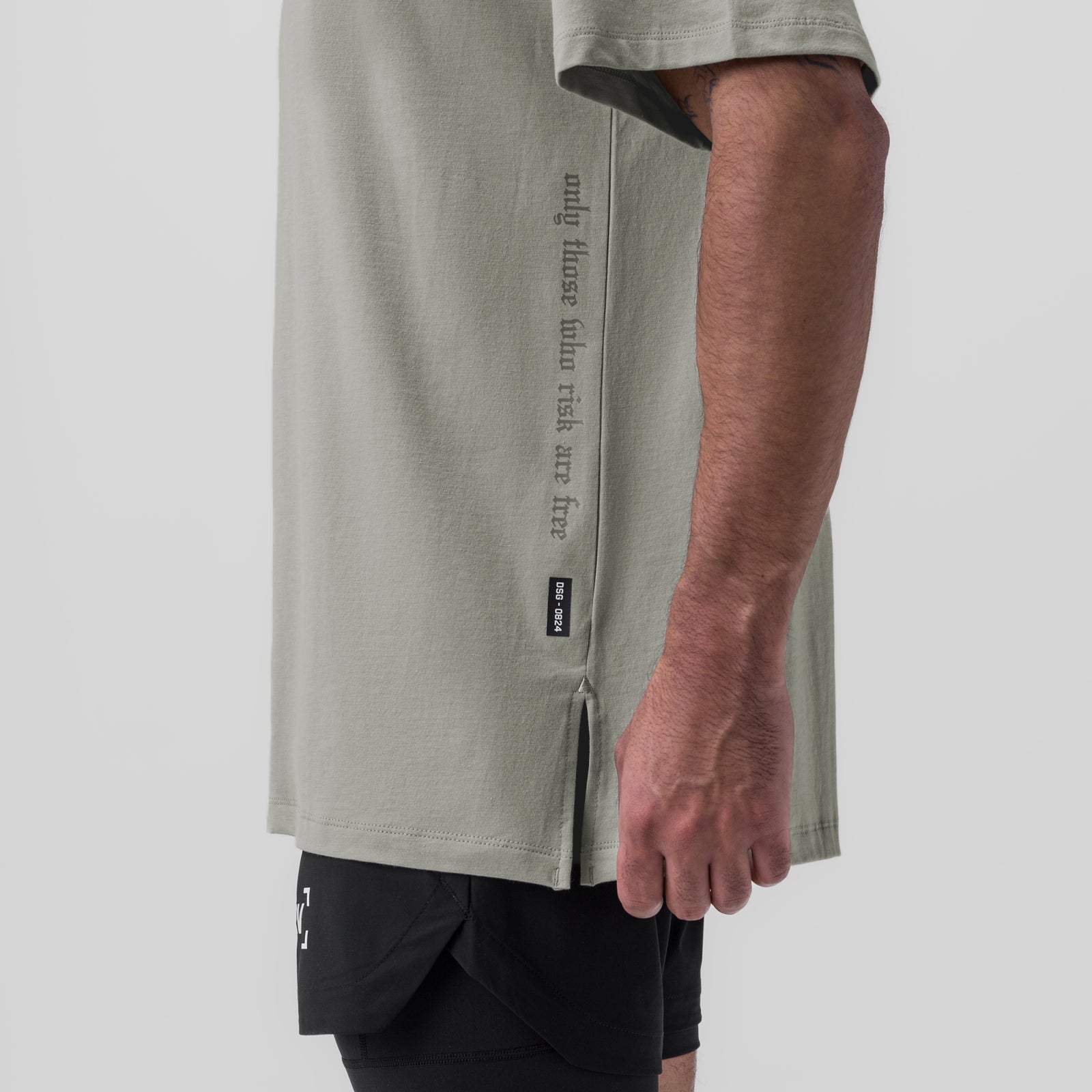 Supima Oversized Tee in sage worn by model, side view showing vertical text graphic