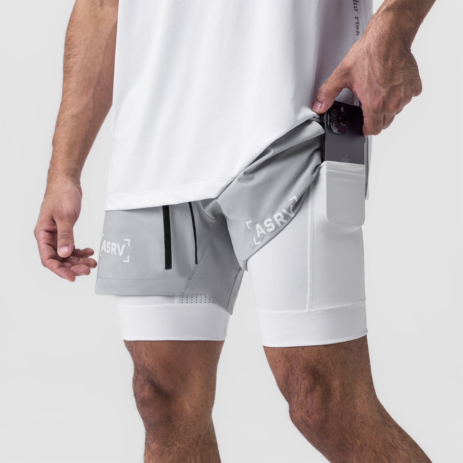 Tetra-Lite 5" Liner Short in Slate Grey and White, model pulling out interior pocket
