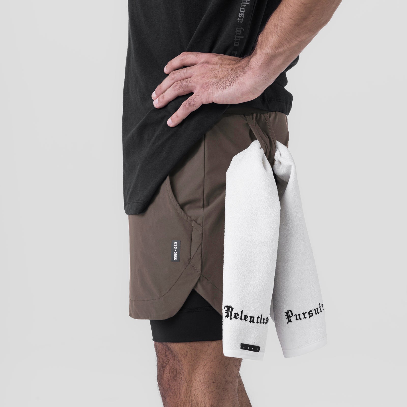 Tetra-Lite 5" Liner Short in deep taupe and black, worn with white towel, side view