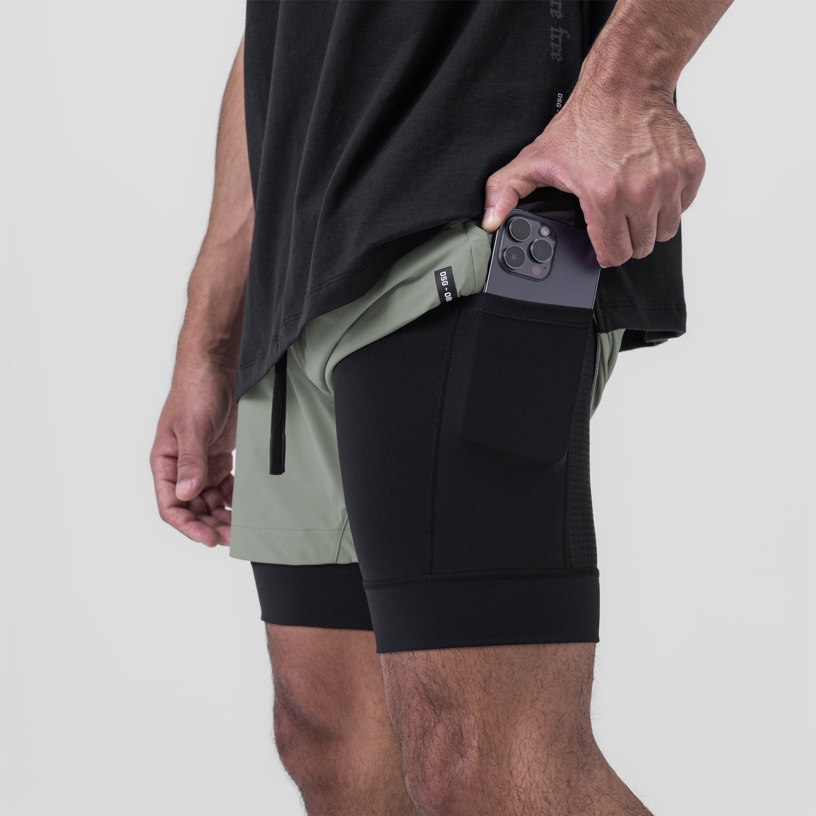 Tetra-Lite 5" Liner Short in Sage/Black, worn with phone in pocket