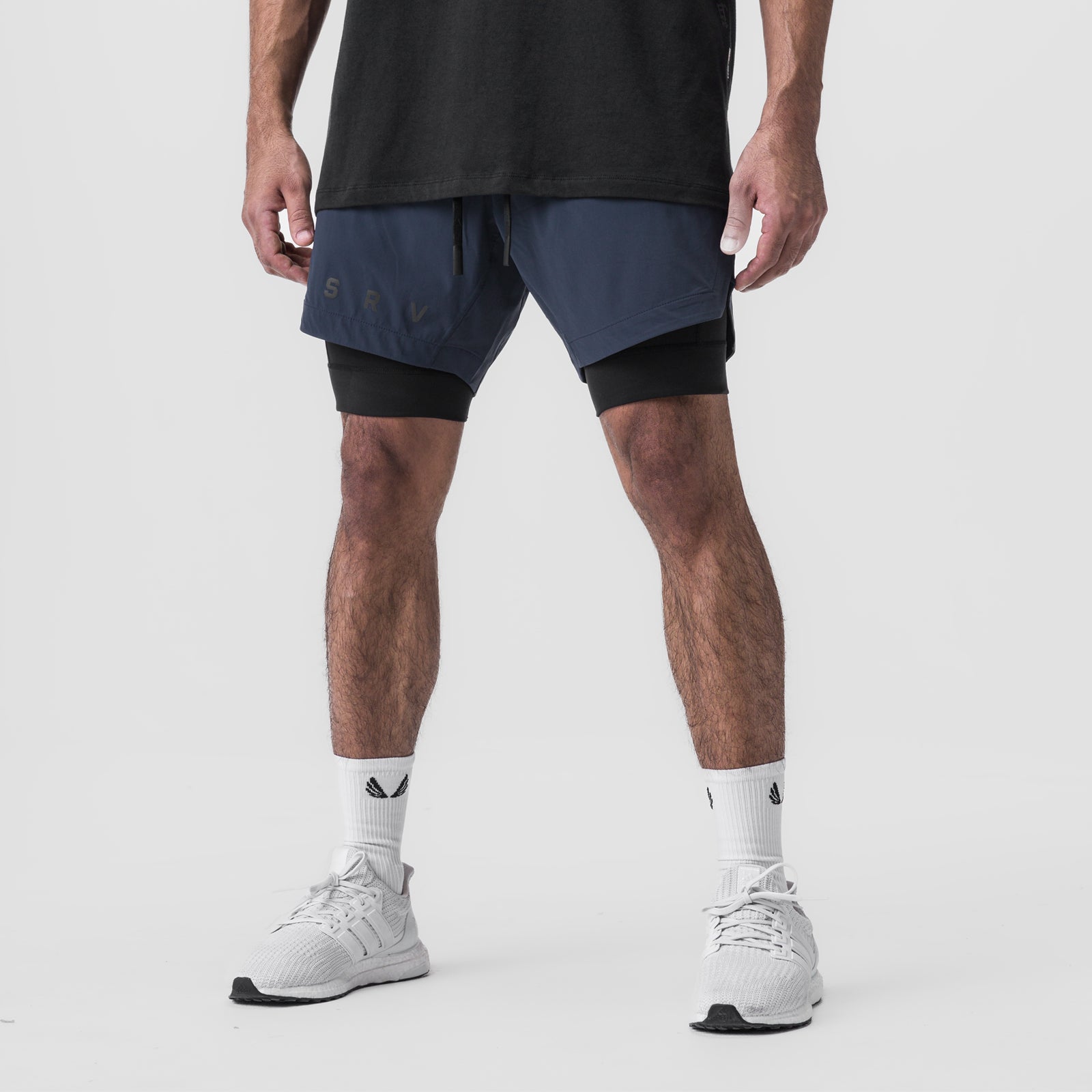 Tetra-Lite 7" Liner Short in Navy and Black worn with white sneakers, front view