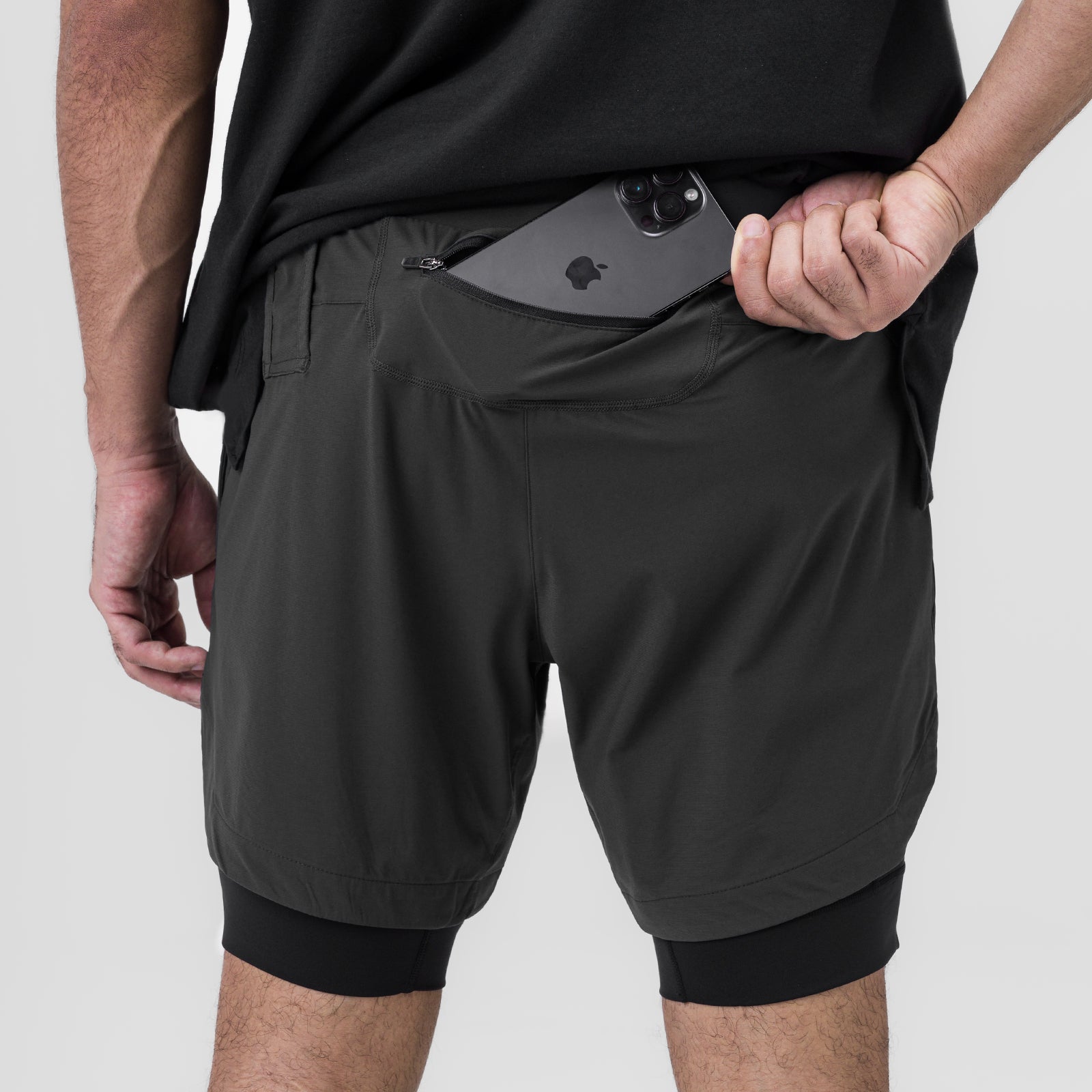 Tetra-Lite 7" Liner Short in Raven, worn by model with phone in pocket, front view