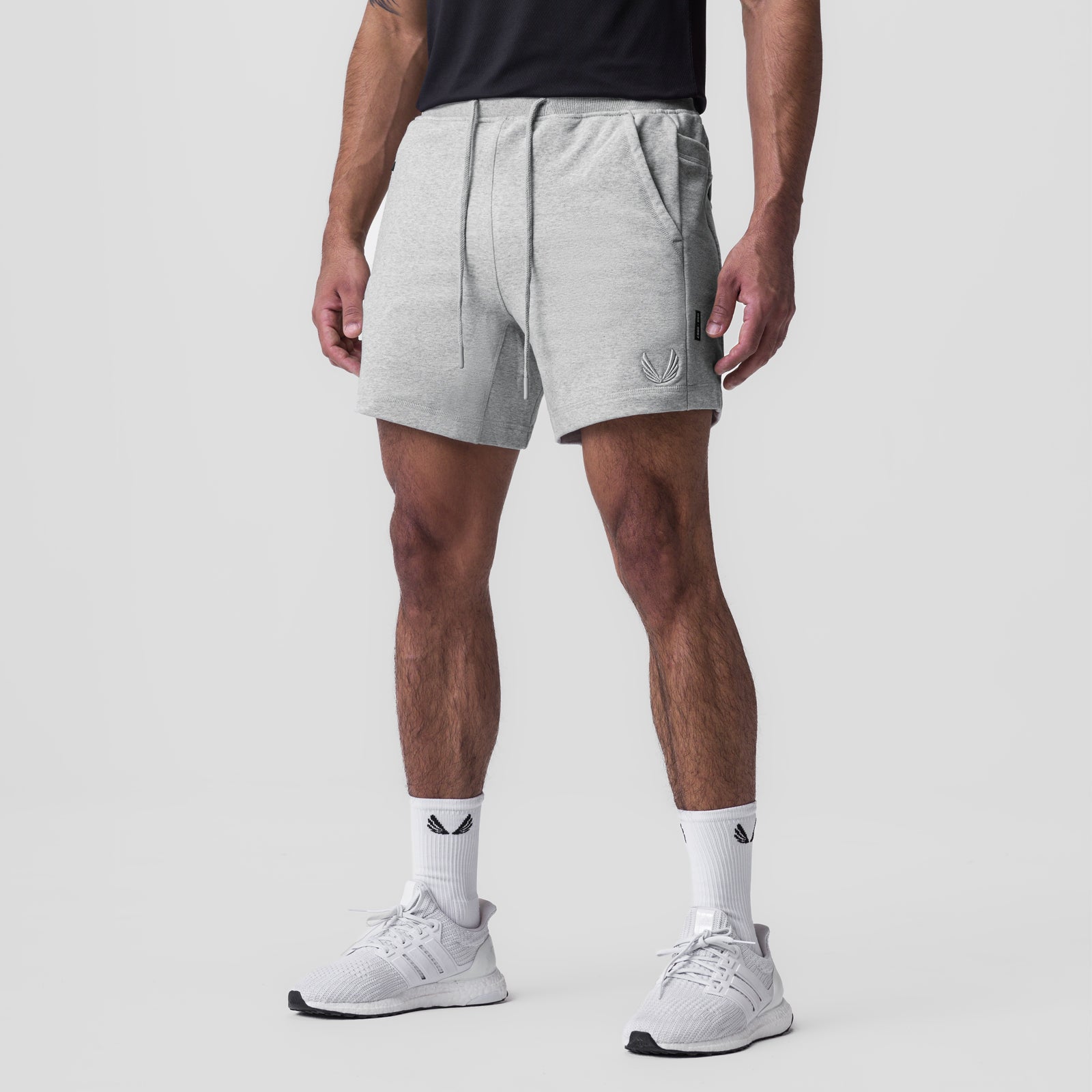 Tech-Terry Sidelock Sweat Short in heather grey, worn by model with white sneakers and socks