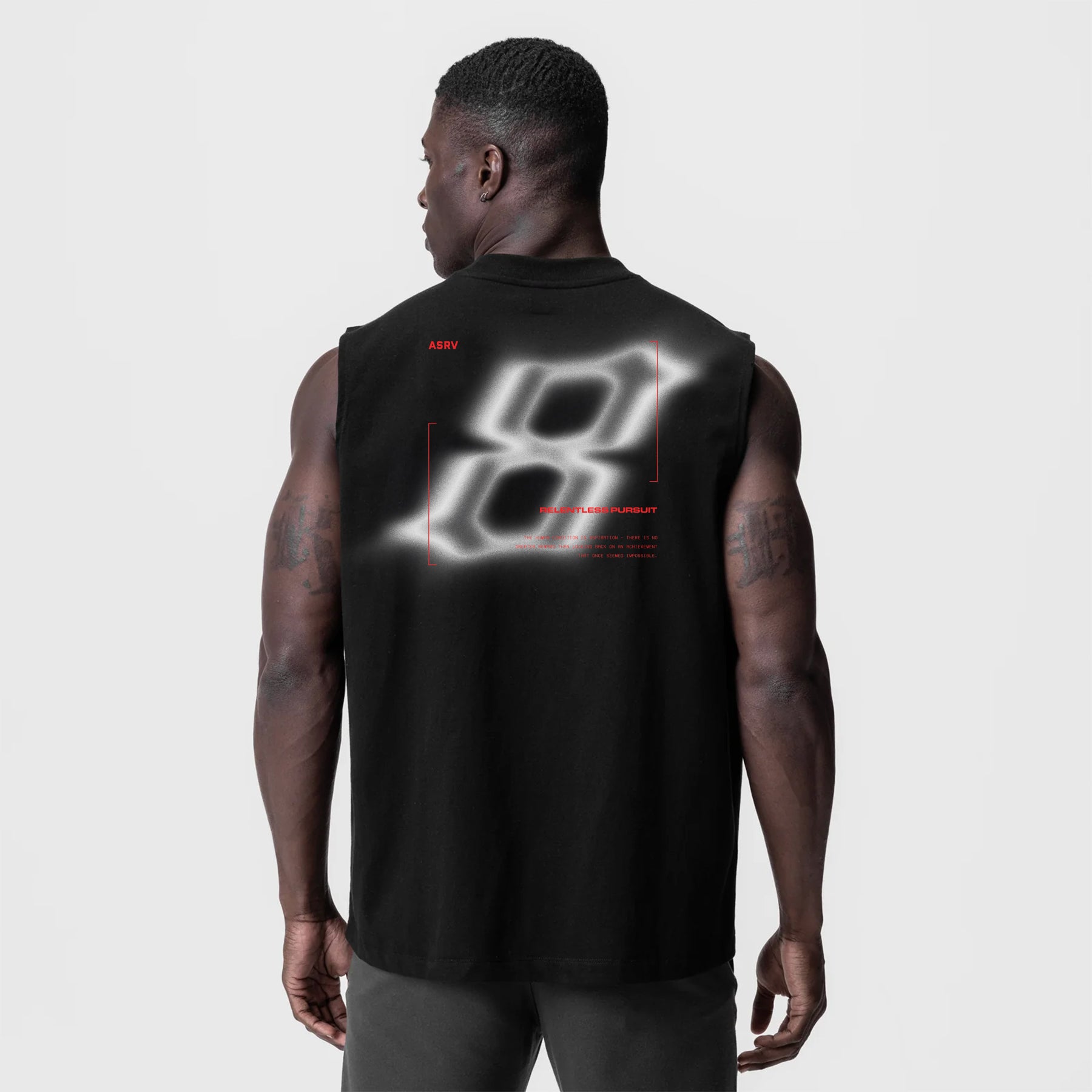 Black Tech Essential Relaxed Cutoff tank top with neon graphic design, back view on model