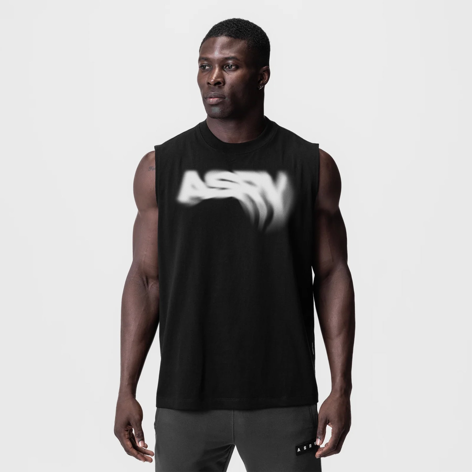 Tech Essential Relaxed Cutoff tank in black with Signal Lost graphic, worn by model, front view
