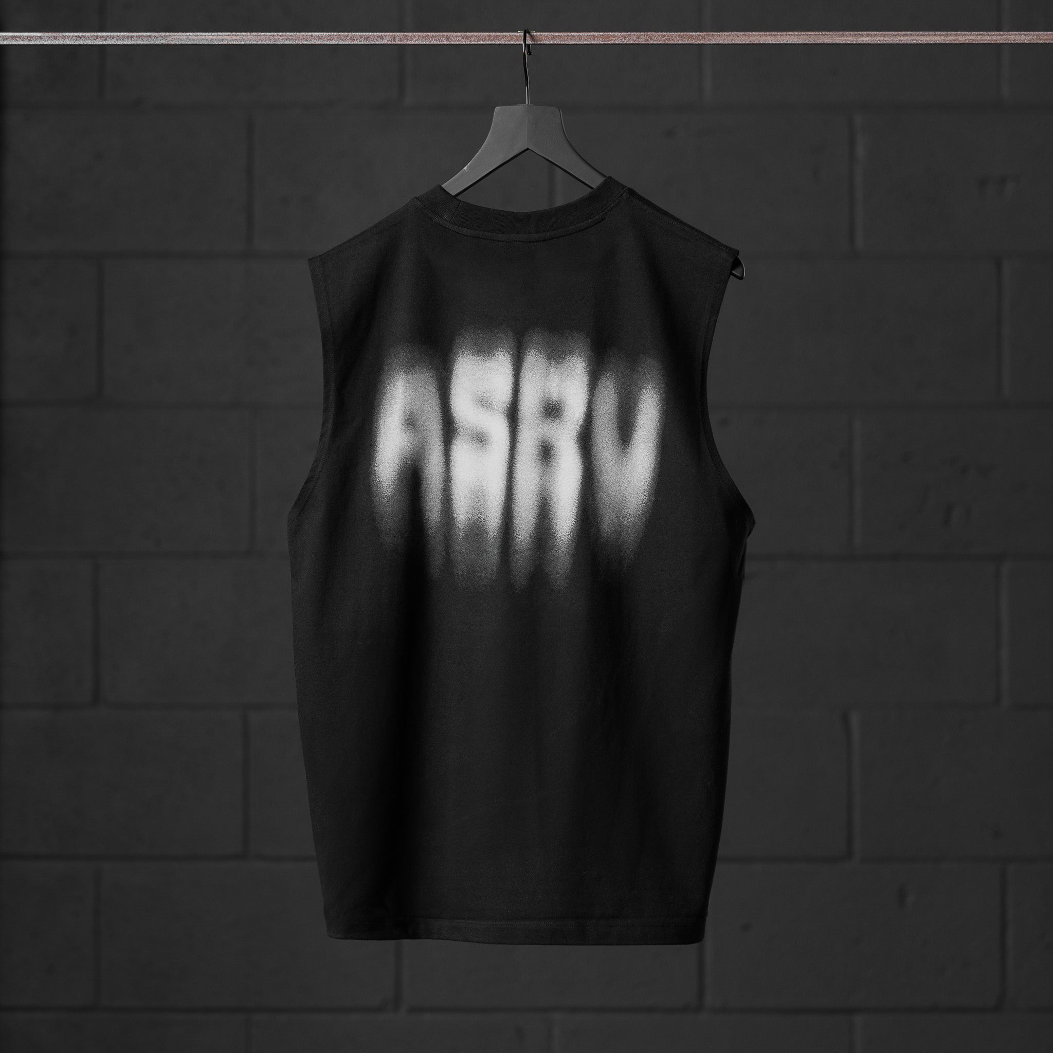 Tech Essential Relaxed Cutoff tank in black with motion blur graphic, back view on hanger