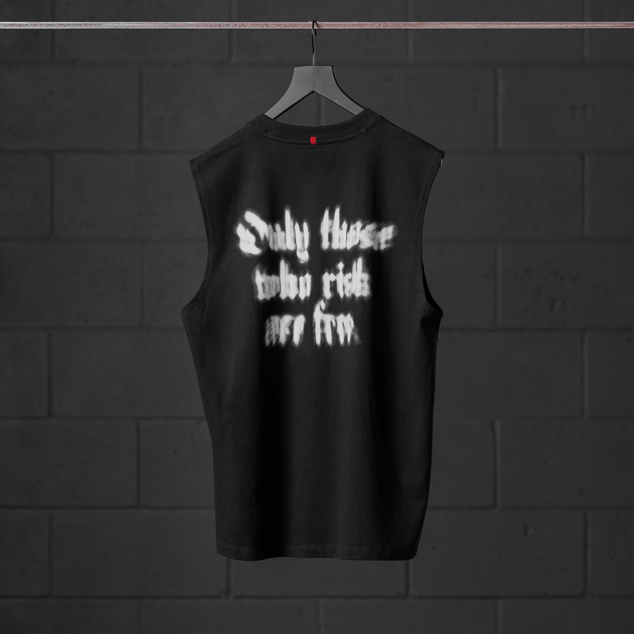 Black Tech Essential Relaxed Cutoff sleeveless tank with white graphic text, back view on hanger