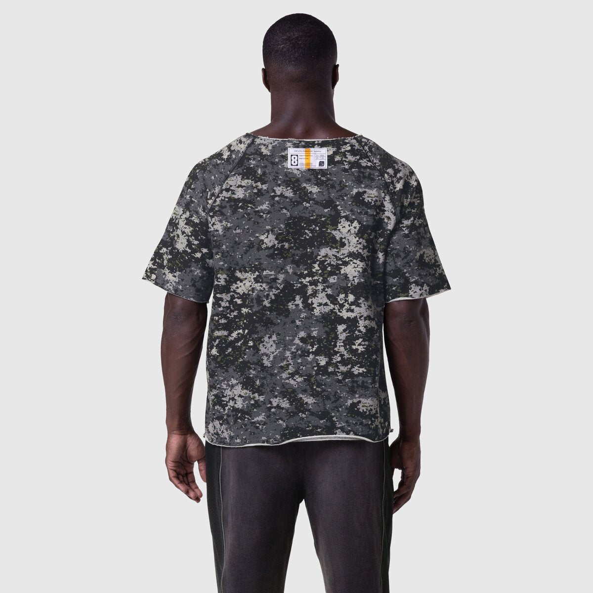 Vintage Raw Hem Pump Cover in pixel camo, worn by model facing away, back view