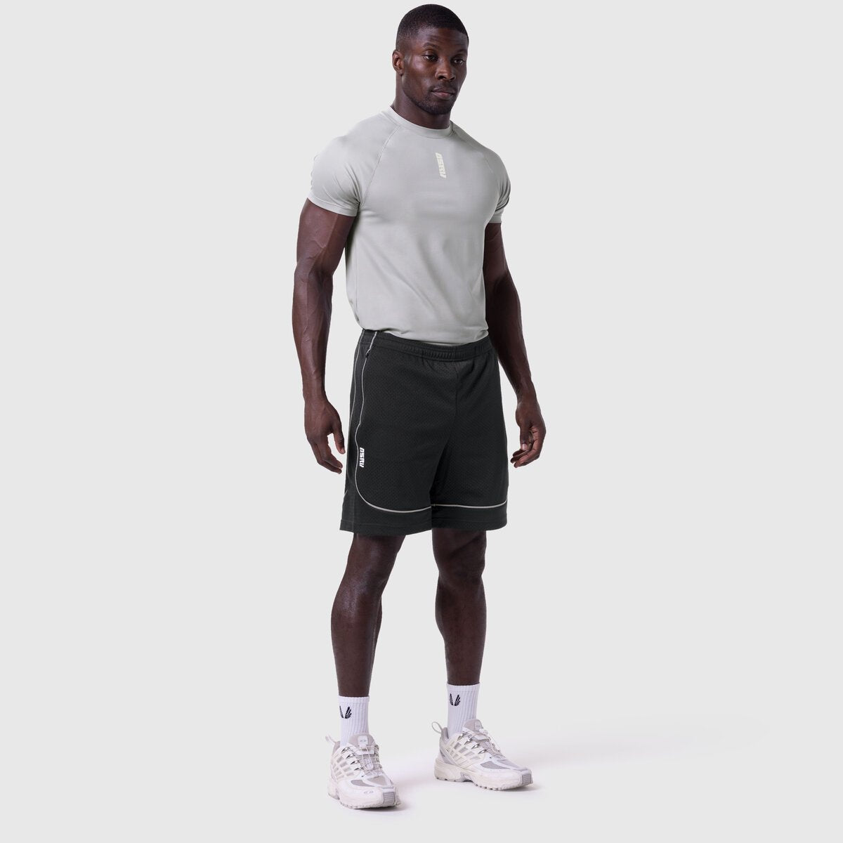 Ion-Mesh Modal Liner Short in black, worn by male model with grey t-shirt and white sneakers