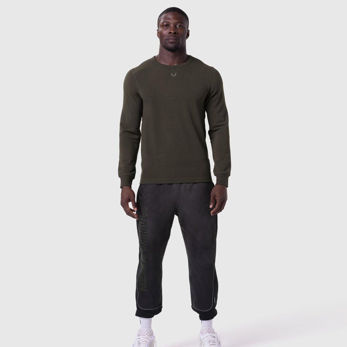 Waffle knit longsleeve in olive worn with black joggers, front view on model