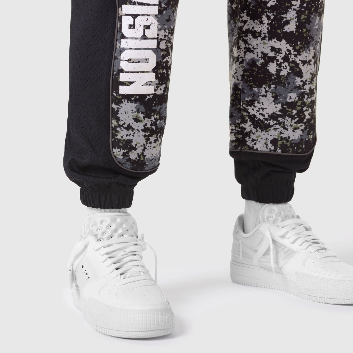 Tech-Terry Mesh Panel Sweats in pixel camo worn with white sneakers, lower body view