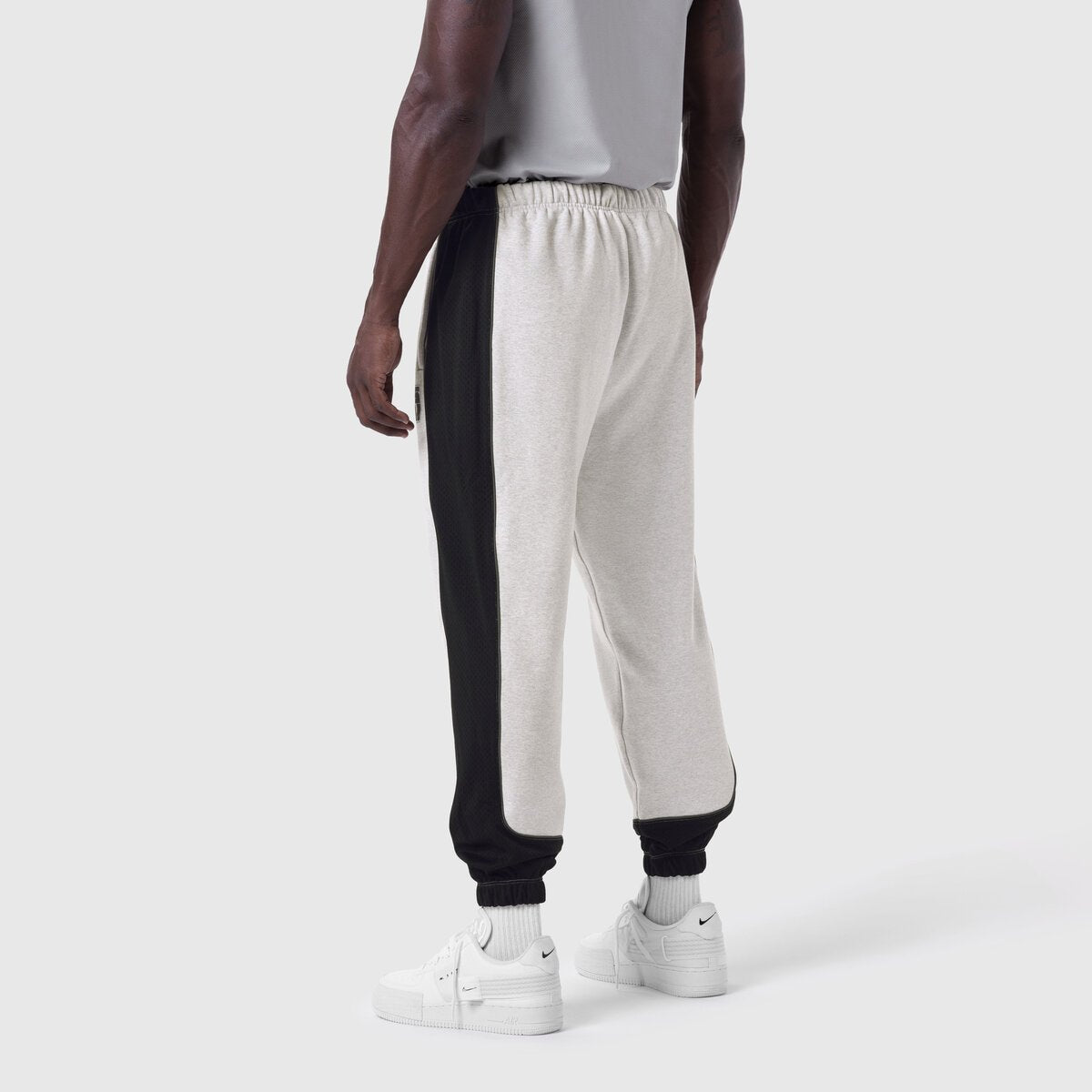 Tech-Terry Mesh Panel Sweats in heather grey and black, worn from behind on model