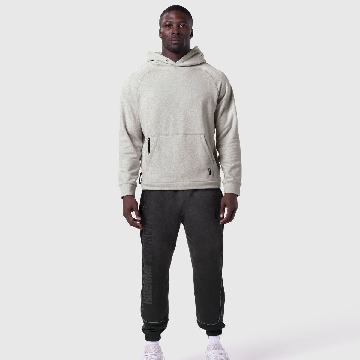 Tech-Terry Training Hoodie in heather grey worn with black joggers, front view