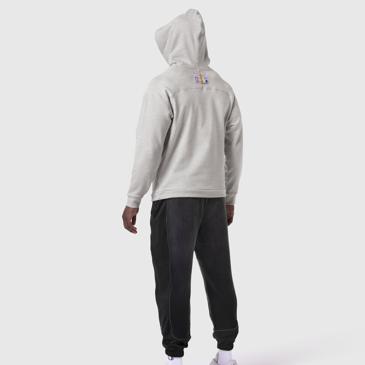Heather grey Tech-Terry Training Hoodie worn by model from back, paired with black joggers