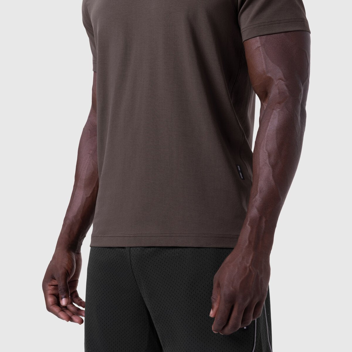 Supima Essential Tee in Dark Earth worn by model, side view showing fit